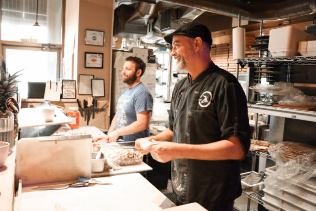 Workers making pizza