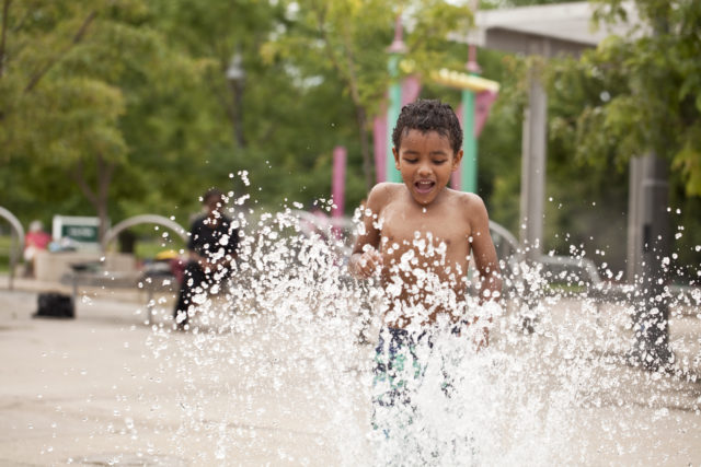 Boy playing at splash pad