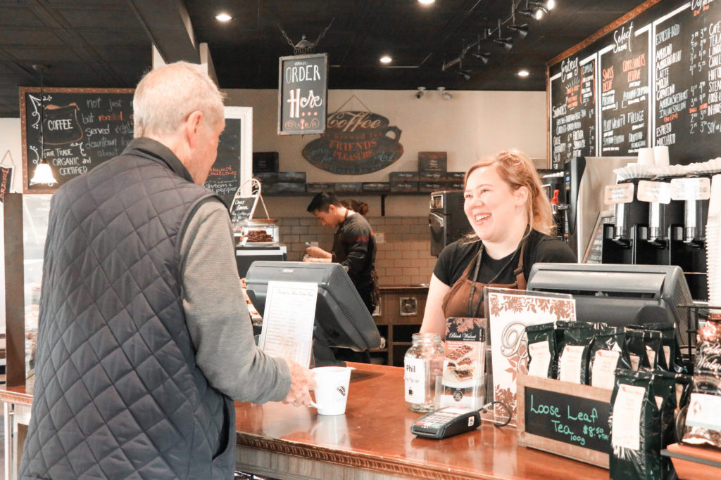 Customer Purchasing Coffee at Black Walnut Cafe