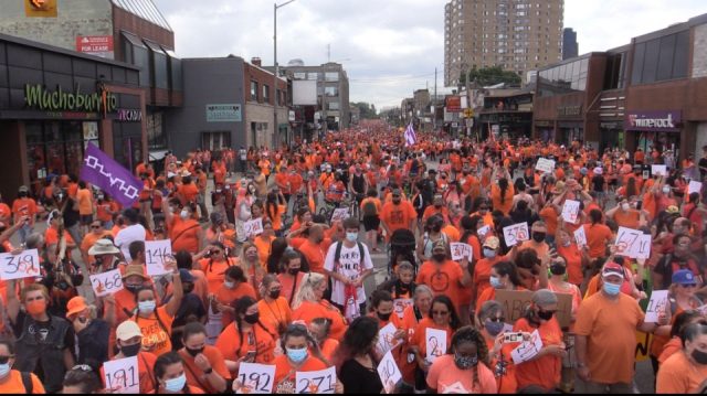 A crowd dressed in orange at Richmond and Oxford for the Turtle Island Healing Walk.